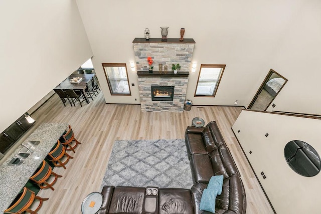 1408 72nd Ave S, Fargo, ND 58104 - living room with wood finished floors, a stone fireplace, and a high ceiling