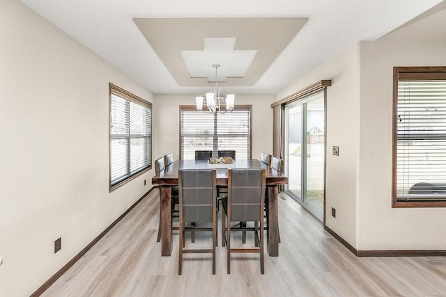 1408 72nd Ave S, Fargo, ND 58104 - dining area featuring baseboards, light wood-style floors, a chandelier, and plenty of natural light