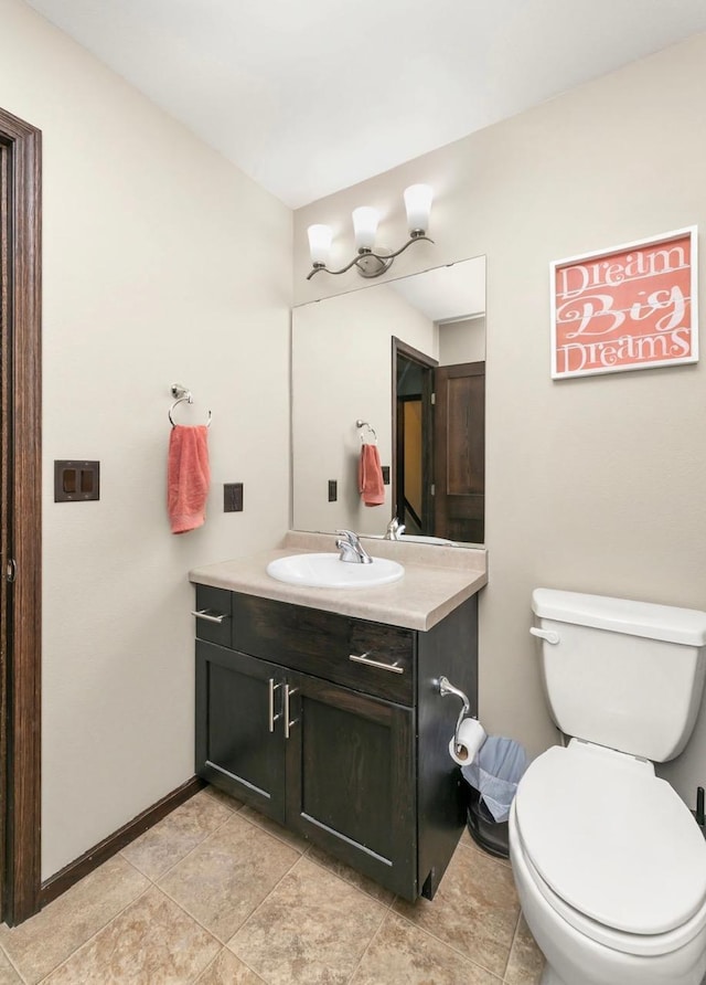 1408 72nd Ave S, Fargo, ND 58104 - half bathroom with vanity, toilet, baseboards, and tile patterned flooring
