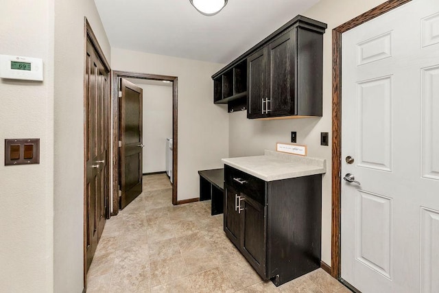 1408 72nd Ave S, Fargo, ND 58104 - laundry room featuring baseboards and cabinet space