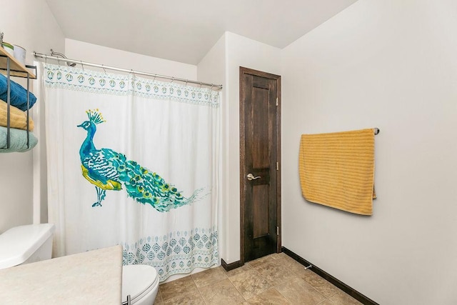 1408 72nd Ave S, Fargo, ND 58104 - bathroom featuring toilet, baseboards, vanity, and a shower with curtain