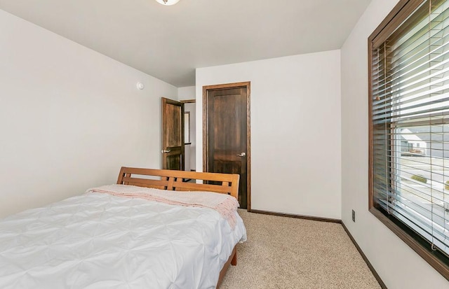 1408 72nd Ave S, Fargo, ND 58104 - bedroom featuring light colored carpet and baseboards