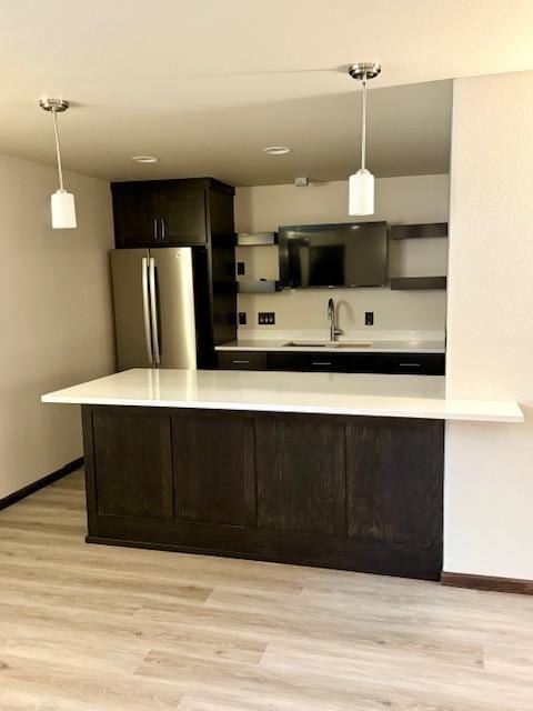 1408 72nd Ave S, Fargo, ND 58104 - kitchen with freestanding refrigerator, open shelves, a sink, baseboards, and light countertops