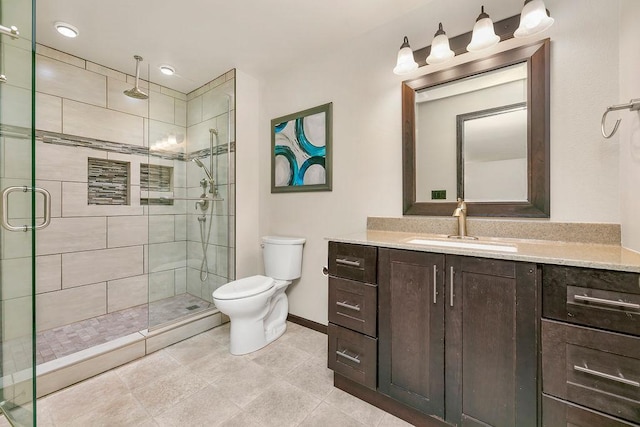 1408 72nd Ave S, Fargo, ND 58104 - bathroom featuring vanity, toilet, a shower stall, baseboards, and tile patterned floors