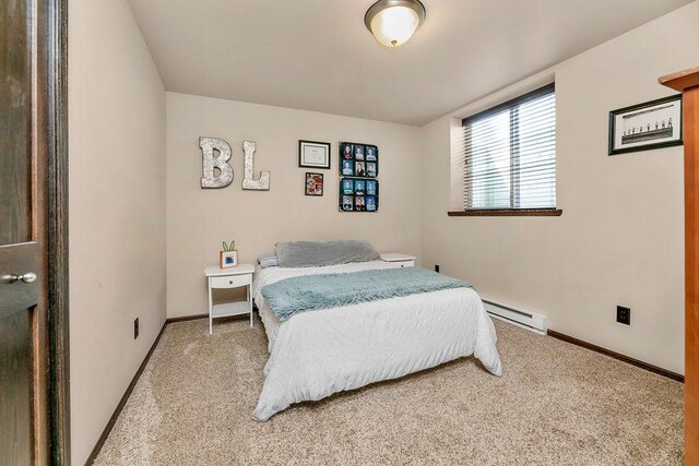 1408 72nd Ave S, Fargo, ND 58104 - bedroom with a baseboard radiator, light carpet, and baseboards