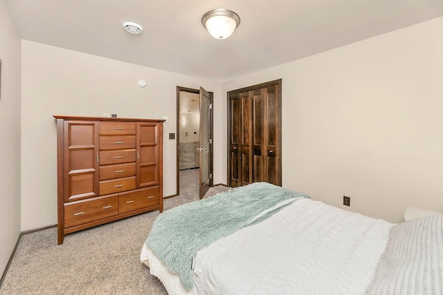 1408 72nd Ave S, Fargo, ND 58104 - bedroom featuring light colored carpet, a closet, baseboards, and connected bathroom