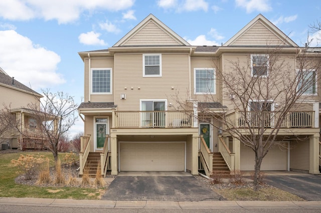 13775 54th Ave N, Plymouth, MN 55446 - view of front of home with stairway, driveway, a garage, and a balcony