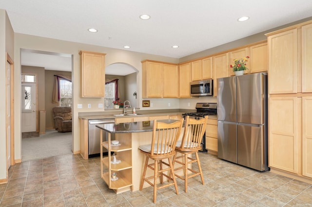 13775 54th Ave N, Plymouth, MN 55446 - kitchen featuring stainless steel appliances, light brown cabinetry, a kitchen breakfast bar, a kitchen island, and recessed lighting