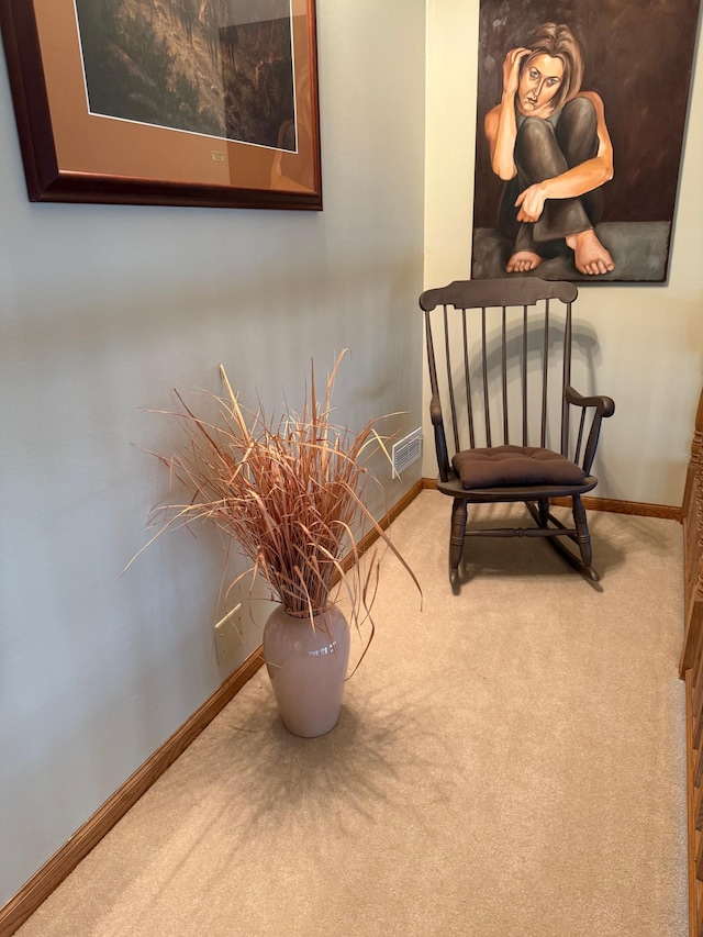 interior space featuring baseboards, visible vents, and carpet