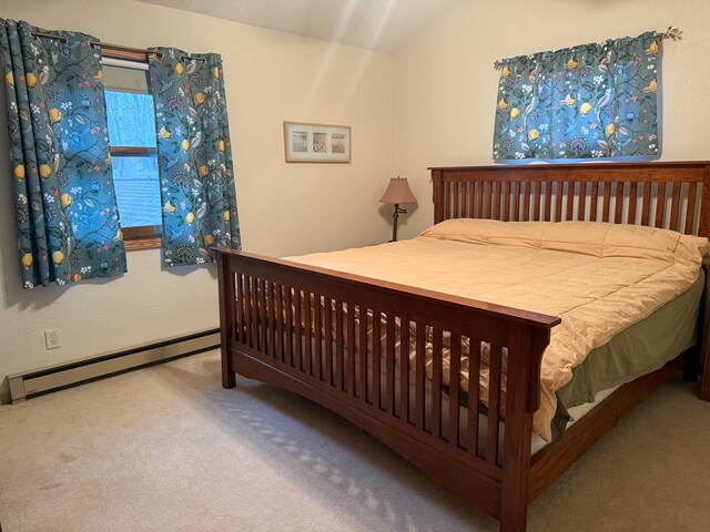 bedroom with baseboards, carpet, and a baseboard heating unit