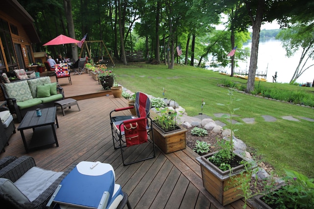 deck featuring a yard, a water view, and outdoor lounge area