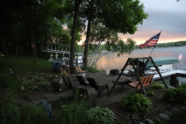 exterior space with a water view and a dock