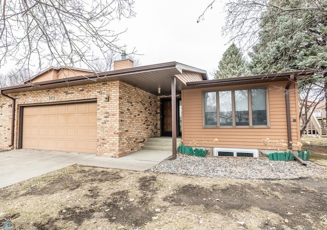 1611 32nd St S, Fargo, ND 58103 - ranch-style home featuring a chimney, concrete driveway, a garage, and brick siding