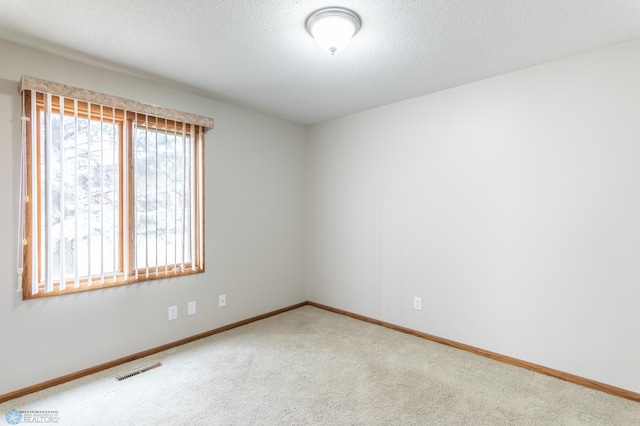 1611 32nd St S, Fargo, ND 58103 - carpeted spare room featuring a textured ceiling, baseboards, and visible vents