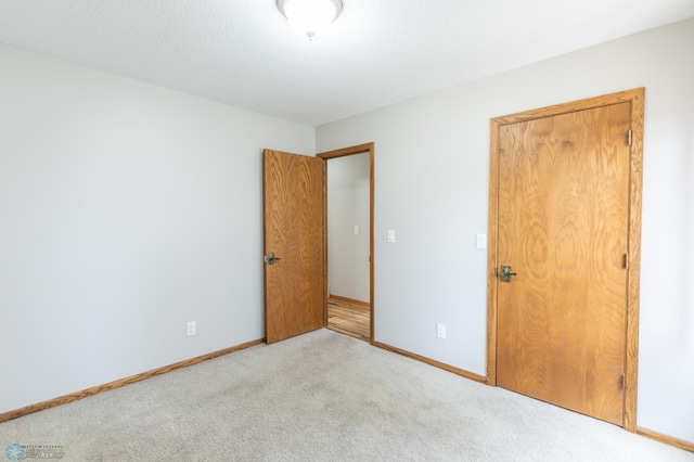 1611 32nd St S, Fargo, ND 58103 - unfurnished bedroom featuring light carpet and baseboards