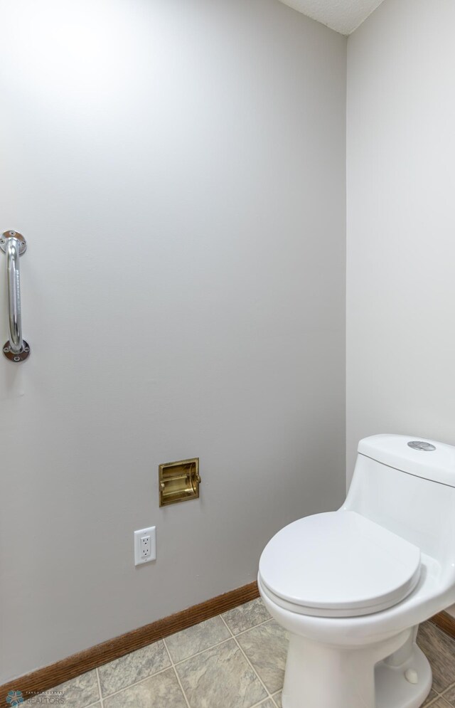 1611 32nd St S, Fargo, ND 58103 - bathroom featuring toilet and baseboards