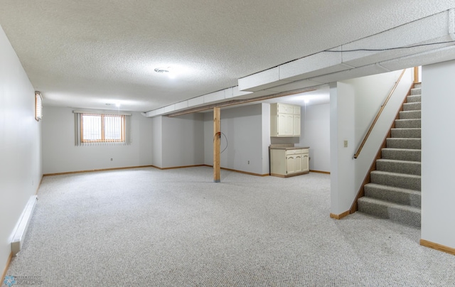 1611 32nd St S, Fargo, ND 58103 - below grade area with light carpet, stairway, baseboards, and a textured ceiling