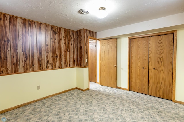 1611 32nd St S, Fargo, ND 58103 - unfurnished bedroom featuring a textured ceiling, baseboards, visible vents, and carpet floors
