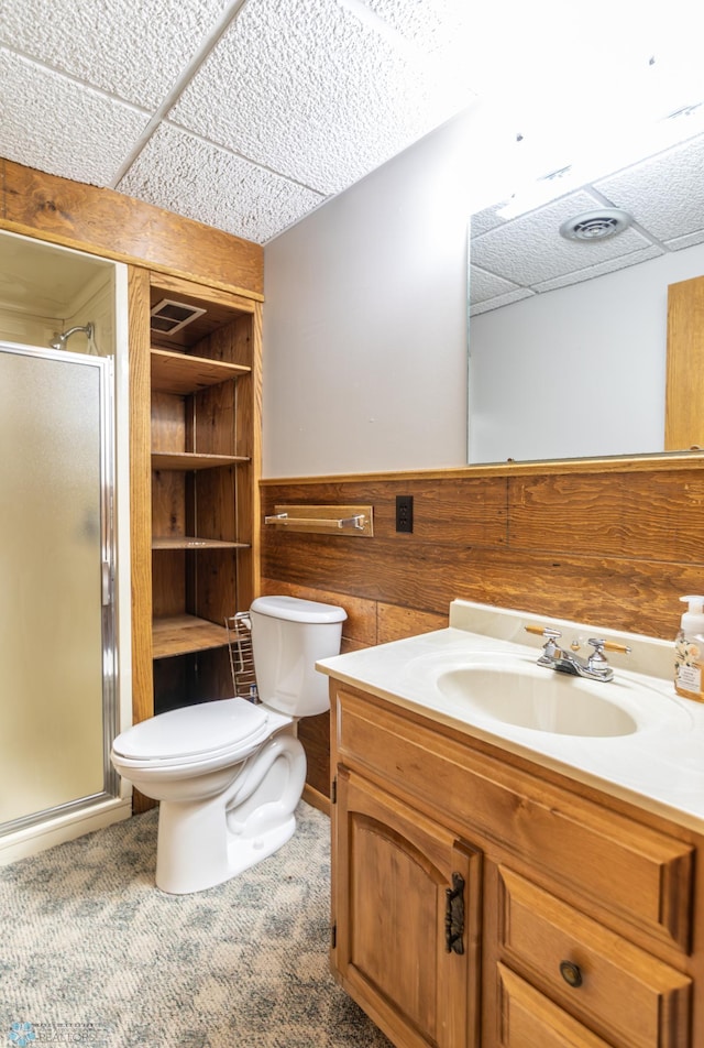 1611 32nd St S, Fargo, ND 58103 - full bathroom featuring toilet, a stall shower, vanity, and wooden walls