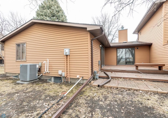 1611 32nd St S, Fargo, ND 58103 - back of house featuring central air condition unit and a chimney
