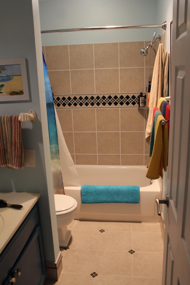 bathroom featuring tile patterned floors, toilet, shower / tub combo with curtain, and vanity