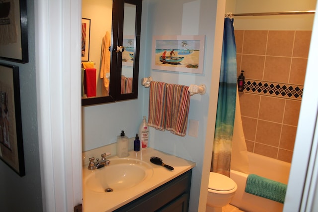 bathroom featuring toilet, vanity, and shower / tub combo