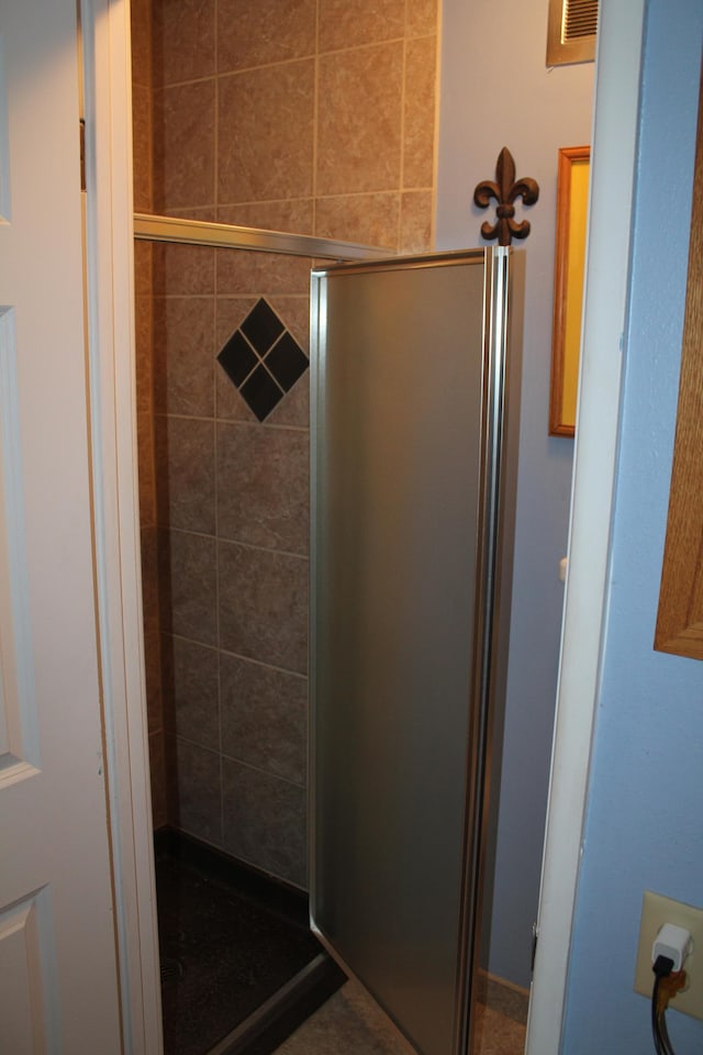 bathroom featuring visible vents and a shower stall