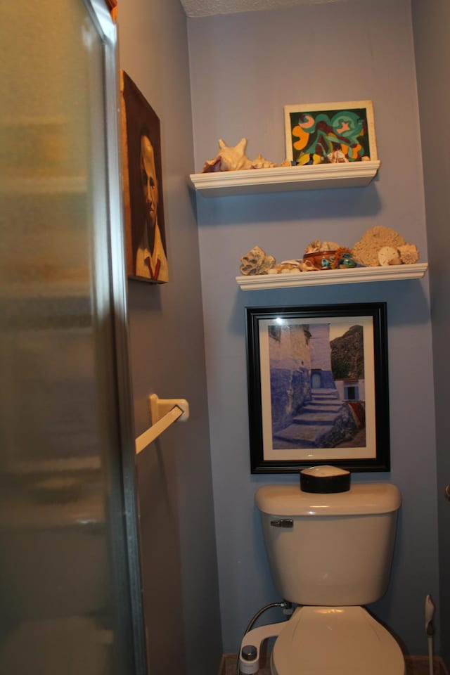 bathroom featuring toilet and baseboards