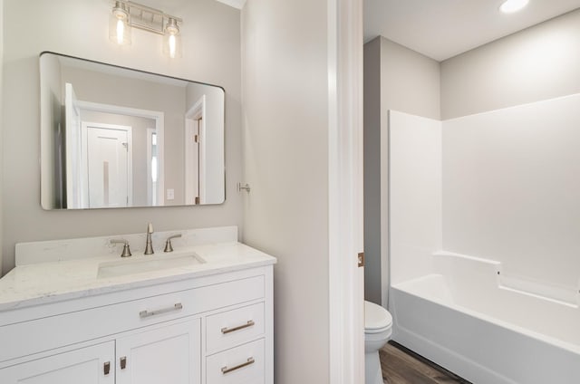 bathroom featuring shower / bath combination, wood finished floors, toilet, and vanity