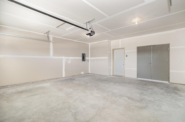garage featuring electric panel and a garage door opener