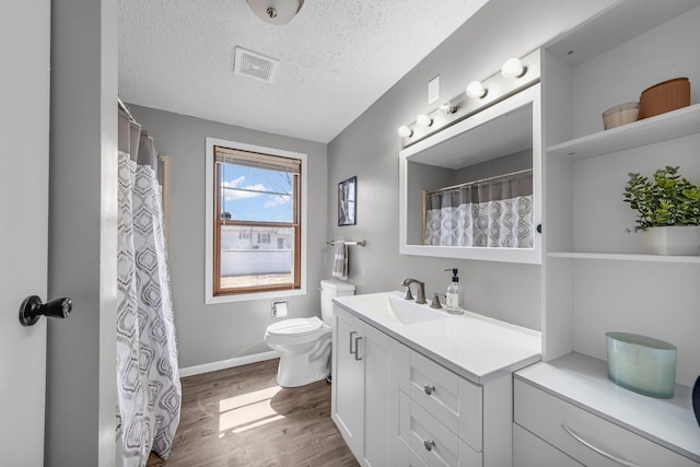 502 Seminole Ave, Osceola, WI 54020 - bathroom featuring vanity, wood finished floors, a textured ceiling, and curtained shower