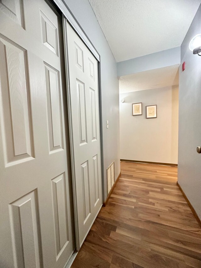 4120 Parklawn Ave Unit 134, Edina, MN 55435 - hall with visible vents, baseboards, a textured ceiling, and wood finished floors