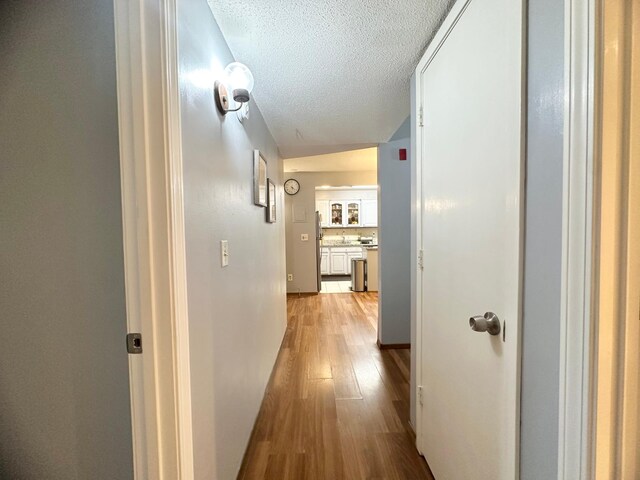 4120 Parklawn Ave Unit 134, Edina, MN 55435 - hallway featuring light wood-style floors and a textured ceiling