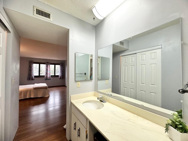 4120 Parklawn Ave Unit 134, Edina, MN 55435 - bathroom with ensuite bath, visible vents, vanity, and wood finished floors