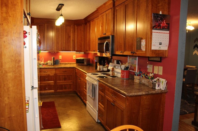 100 Park Rd, Staples, MN 56479 - kitchen featuring white appliances, brown cabinetry, and pendant lighting