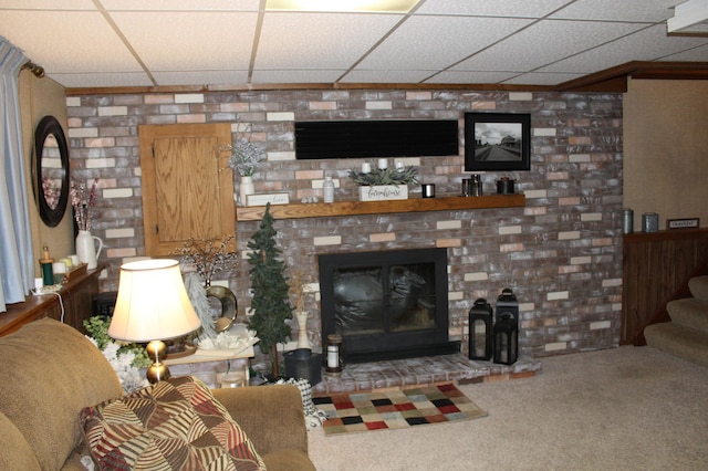 100 Park Rd, Staples, MN 56479 - living area with carpet floors, a drop ceiling, stairway, and a glass covered fireplace