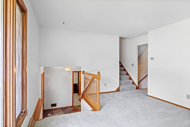 stairs with carpet and baseboards
