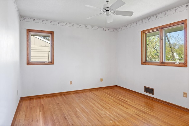 unfurnished room with light wood-type flooring, baseboards, and a ceiling fan