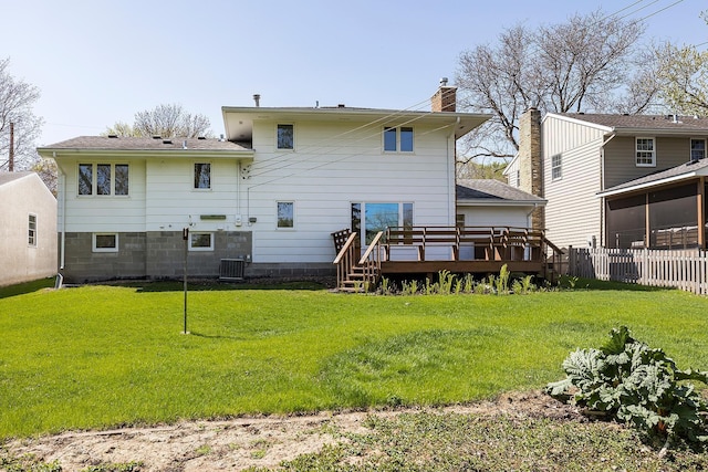 back of house featuring central AC unit, a deck, and a chimney