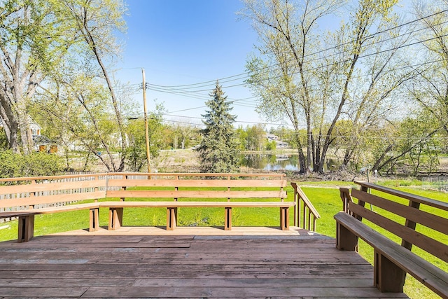 wooden deck with a water view and a yard