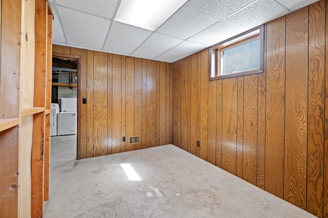 below grade area featuring washing machine and dryer and wooden walls
