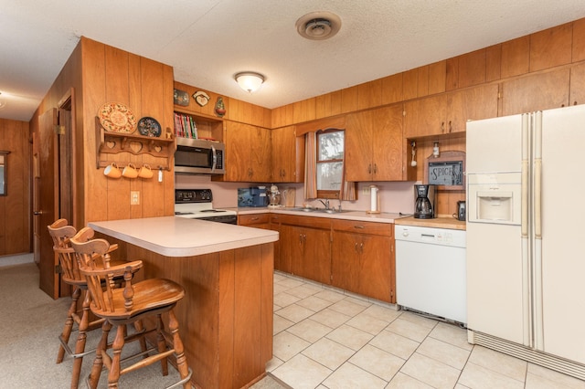 8236 Lake Carlos Dr NE, Carlos, MN 56319 - kitchen with white appliances, brown cabinets, a peninsula, open shelves, and light countertops