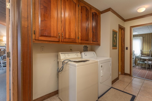 8236 Lake Carlos Dr NE, Carlos, MN 56319 - laundry room with washing machine and clothes dryer, cabinet space, crown molding, baseboards, and light tile patterned floors