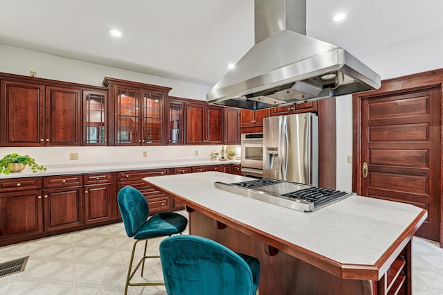 3220 50th Ave, Cady Twp, WI 54749 - kitchen with island range hood, appliances with stainless steel finishes, light countertops, dark brown cabinets, and a kitchen island