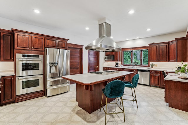 3220 50th Ave, Cady Twp, WI 54749 - kitchen featuring appliances with stainless steel finishes, island exhaust hood, light floors, light countertops, and recessed lighting
