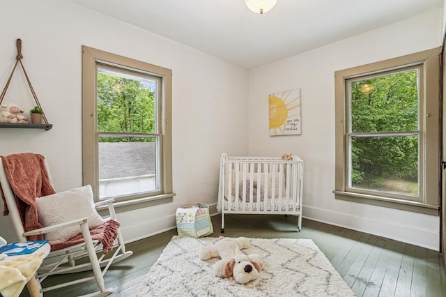 3220 50th Ave, Cady Twp, WI 54749 - bedroom with multiple windows, wood-type flooring, and baseboards