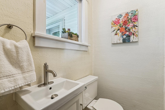 3220 50th Ave, Cady Twp, WI 54749 - bathroom with toilet, a textured wall, and vanity