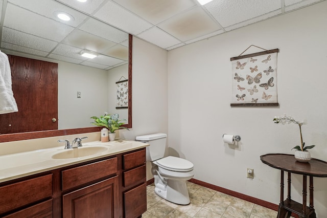 3220 50th Ave, Cady Twp, WI 54749 - bathroom with a drop ceiling, toilet, vanity, and baseboards