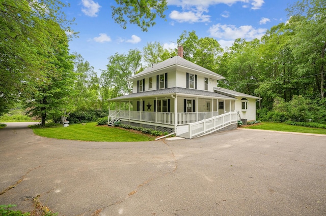 3220 50th Ave, Cady Twp, WI 54749 - country-style home featuring a porch, a chimney, a front lawn, and a shingled roof