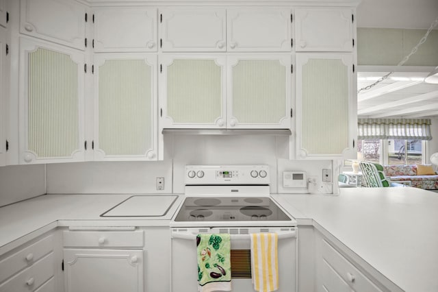 kitchen with white electric range, light countertops, white cabinetry, and under cabinet range hood